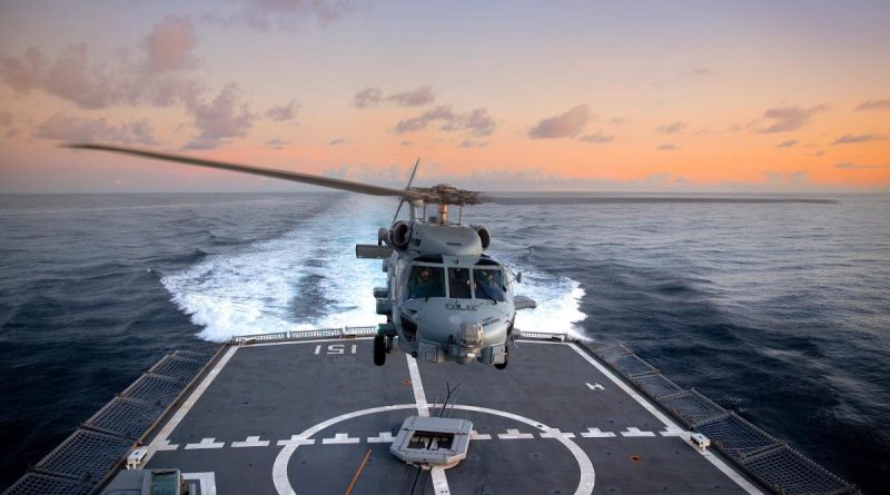 HMAS Arunta’s embarked MH-60R helicopter Athena conducts flying operations as the ship transits through the Indonesian archipelago during a regional presence deployment. Story by Lieutenant Commander Andrew Herring. Photo by Able Seaman Susan Mossop.