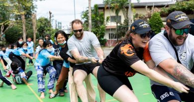 HMAS Arunta sailors take on the children from the Father Ray Foundation in Sattahip, Thailand, in a tug of war. Story by Lieutenant Chayce Pullen. Photo by Leading Seaman Susan Mossop.