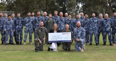 Air Force SRG personnel. Front: (l-r) Squadron Leader Lachlan Adam, Anglicare Fundraising Coordinator Tammy Rees, Officer Commanding 92 Wing Group Captain Paul Carpenter and Sergeant Richard Wren at RAAF Base Edinburgh, SA. Photo by Sergeant Bill Solomou.