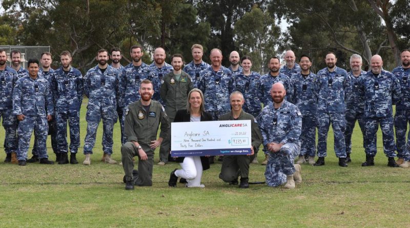 Air Force SRG personnel. Front: (l-r) Squadron Leader Lachlan Adam, Anglicare Fundraising Coordinator Tammy Rees, Officer Commanding 92 Wing Group Captain Paul Carpenter and Sergeant Richard Wren at RAAF Base Edinburgh, SA. Photo by Sergeant Bill Solomou.