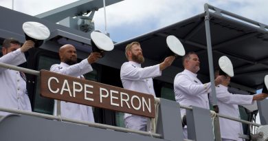 The ship's company of Australian Defence Vessel Cape Peron, 'cheer-ship' during an official welcome to home port HMAS Cairns. Story by Lieutenants Max Logan and Gary McHugh. Photo by Seaman Lauren Pugsley.