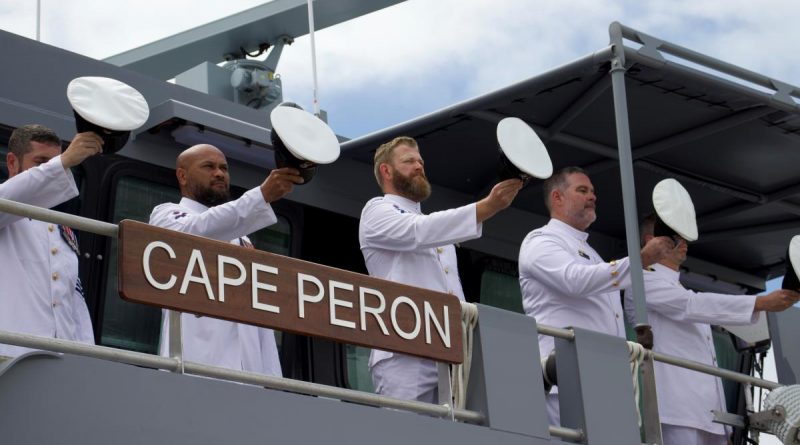 The ship's company of Australian Defence Vessel Cape Peron, 'cheer-ship' during an official welcome to home port HMAS Cairns. Story by Lieutenants Max Logan and Gary McHugh. Photo by Seaman Lauren Pugsley.