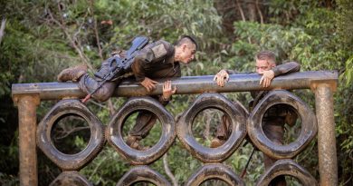 French Armed Forces in New Caledonia soldier Private Thimeo, left, climbs over a vertical tyre obstacle during Exercise True Grit at the Tully training area, Queensland. Story and photo by Sergeant Matthew Bickerton.