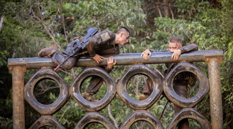 French Armed Forces in New Caledonia soldier Private Thimeo, left, climbs over a vertical tyre obstacle during Exercise True Grit at the Tully training area, Queensland. Story and photo by Sergeant Matthew Bickerton.