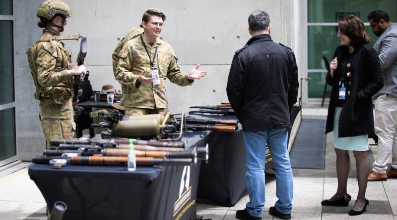 Captain Damien Freeman talks about captured enemy weapons during a display by the Australian Army History Unit at Russell Offices, Canberra. Story by Private Nicholas Marquis. Photo by Sergeant Matthew Bickerton.