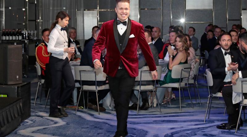 Signaller Harry Gifford walks up to the stage to collect the award for Excellence and Inclusion, at the Defence Gay and Lesbian Information Service Military Pride Ball in Sydney. Story by Private Nicholas Marquis. Photo by Ann-Marie Calilhanna.