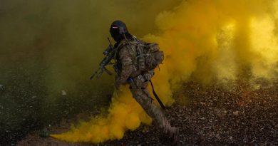 Army rifleman from Charlie Company of the 8th/9th Battalion, Royal Australian Regiment, uses smoke as cover to make entry into a building as part of Exercise Ram Horn IV. Story by Captain Cody Tsaousis. Photo by Corporal Nicole Dorrett.