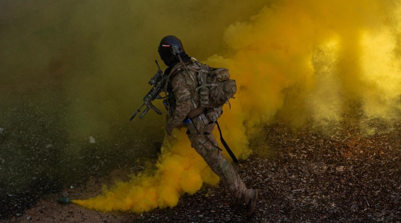 Army rifleman from Charlie Company of the 8th/9th Battalion, Royal Australian Regiment, uses smoke as cover to make entry into a building as part of Exercise Ram Horn IV. Story by Captain Cody Tsaousis. Photo by Corporal Nicole Dorrett.
