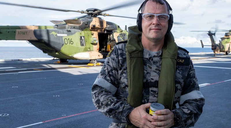 Petty Officer Jean Metcalf on the flight deck of HMAS Adelaide before scattering his father's ashes from an MRH-90 Taipan. Story by Lieutenant Emma Anderson. Photo by Leading Seaman Sittichai Sakonpoonpol.