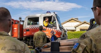 Australian Army soldiers and a local resident speak with a NSW Rural Fire Service volunteer in Forbes. Story by Captain Zoe Griffyn. Photo by Corporal David Cotton.