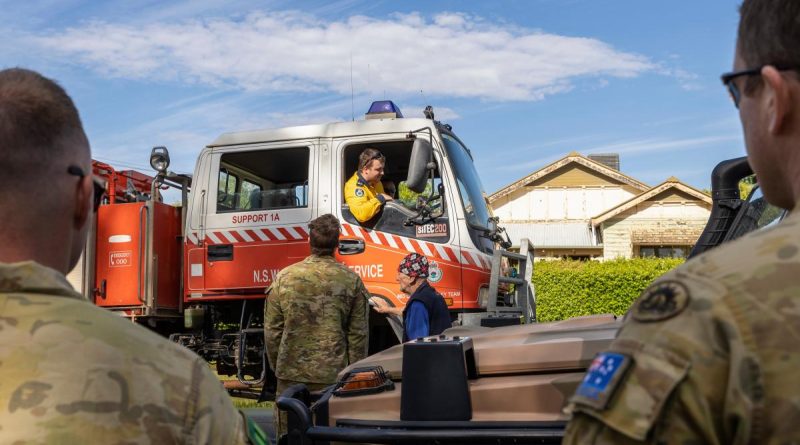 Australian Army soldiers and a local resident speak with a NSW Rural Fire Service volunteer in Forbes. Story by Captain Zoe Griffyn. Photo by Corporal David Cotton.
