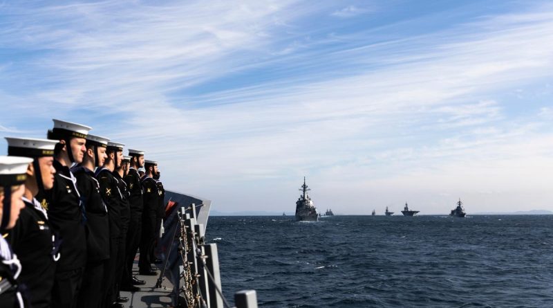 HMAS Hobart prepares to sail past the reviewing ship, Japan Maritime Self-Defense Force helicopter carrier JS Izumo, during the International Fleet Review 2022 off the coast of Yokosuka, Japan. Story by Lieutenant Brendan Trembath. Photo by Leading Seaman Daniel Goodman.