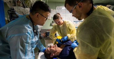 Royal Australian Navy and Royal Malaysian Navy medical officers a capability demonstration on a volunteer casualty in HMAS Adelaide's resuscitation bay as part of Indo-Pacific Endeavour 2022. Story by Flying Officer Brent Moloney. Photo by Leading Seaman Sittichai Sakonpoonpol.