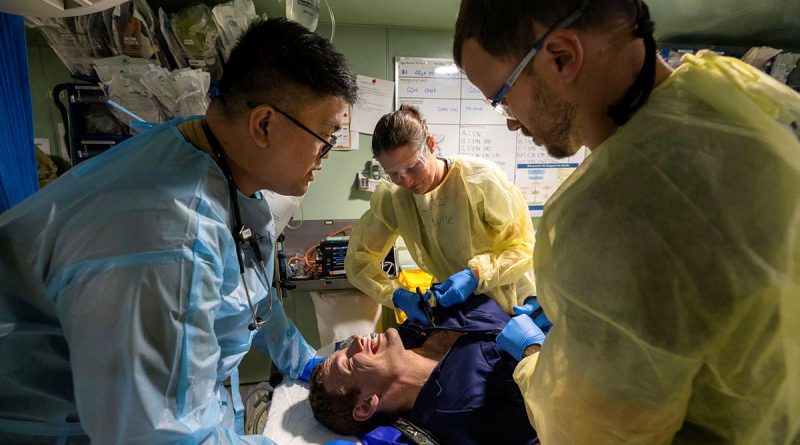 Royal Australian Navy and Royal Malaysian Navy medical officers a capability demonstration on a volunteer casualty in HMAS Adelaide's resuscitation bay as part of Indo-Pacific Endeavour 2022. Story by Flying Officer Brent Moloney. Photo by Leading Seaman Sittichai Sakonpoonpol.