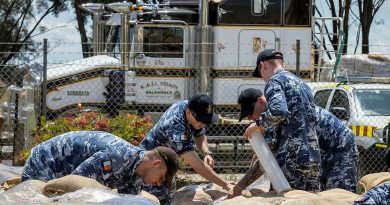 Air Force personnel wrap sandbag pallets for transportation at the New South Wales State Emergency Service depot in Forbes, during Operation Flood Assist. Story by Captain Zoe Griffyn. Photo by Corporal David Cotton.