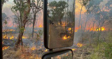 Leading Aircraftwoman Toni Rutherford, a firefighter from 17 Squadron, on the rear deck of a fire truck near Katherine. Story by Flight Lieutenant Joshua Fuad. Photo by Flight Sergeant Mark Egan.