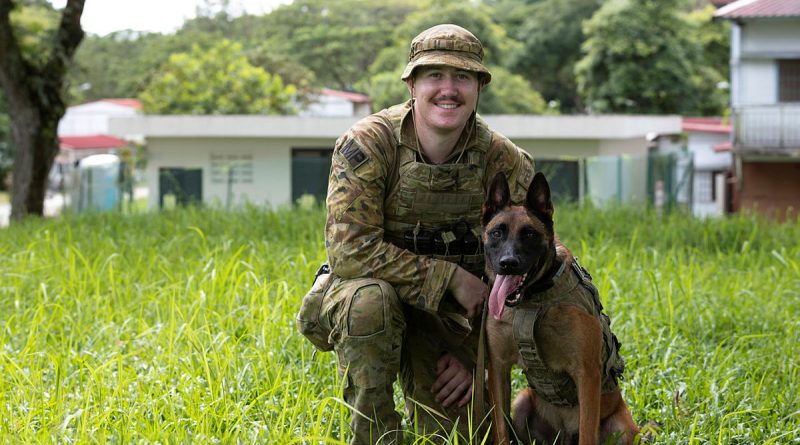 Military Police Dog Handler Private Aidan Fleming with his working dog Drago after taking part in urban warfare training in Singapore. Story by Lieutenant Amy Johnson. Photo by Leading Seaman Nadav Harel.