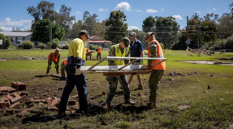 ADF personnel assist council workers to restore the memorial located in Eugowra, NSW, during Operation Flood Assist 22-2. Story by Captain Joanne Leca. Photo by Corporal Madhur Chitnis.