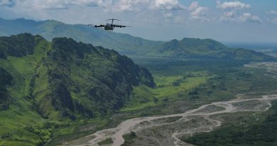 A RAAF C-17 Globemaster III flies in a 2-ship formation with a US Air Force C-17 over Papua New Guinea. Story by By Flight Lieutenant Tanya Carter. Photo by Staff Sergeant Alan Ricker.