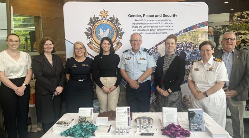 Air Commodore Grant Pinder with members of the Gender, Peace and Security Directorate and Joint Support Services Division at an information stand in Canberra. Story by Sam Cuninghame. Photo by Emily Egan.