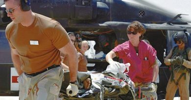 Australian Army Sergeant Tarese Heath (operating ventilator) and US colleagues transfer a wounded patient from a medical evacuation helicopter to the Emergency Department of the Air Force Theater Hospital at Balad, Iraq. Photo by Major Patricia Anderson, US Army.