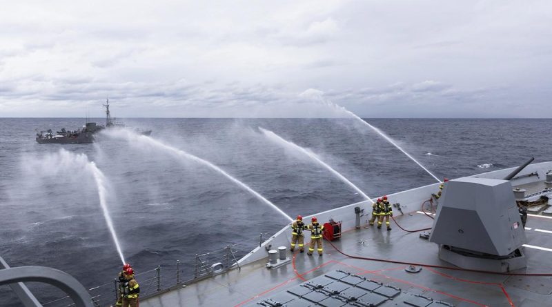 HMAS Hobart's ship's company render firefighting assistance to Japan Maritime Self-Defense Force minesweeping tender JS Bungo during a damage control exercise. Story and photo by Leading Seaman Daniel Goodman.