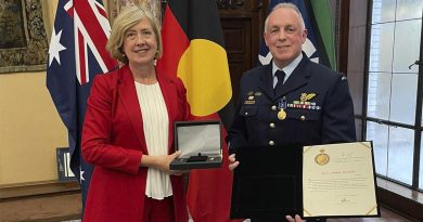 Warrant Officer Sean McClure standing with Australia’s Acting High Commissioner to London, Lynette Wood, with his Medal of the Order of Australia. Story by Lieutenant Commander John Thompson.