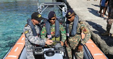 From left, RAN Chief Petty Officer Christian Duncan instructs 2TEN Mario Arujo and GRT Ezaqiel Ximenes in a Guardian-class patrol boat. Story by Lieutenant Emma Anderson. Photo by Mrs Juliana Pereira.