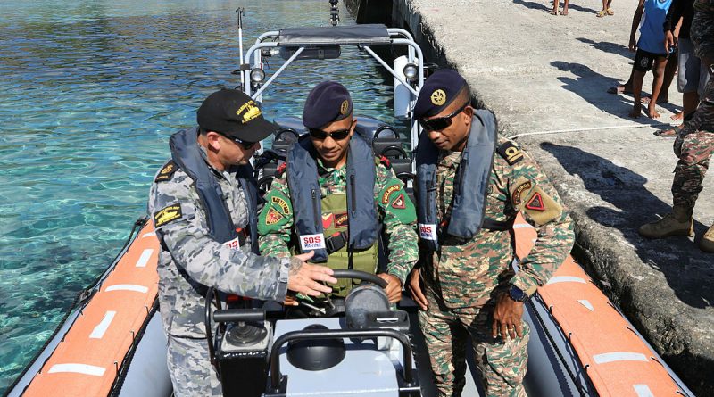 From left, RAN Chief Petty Officer Christian Duncan instructs 2TEN Mario Arujo and GRT Ezaqiel Ximenes in a Guardian-class patrol boat. Story by Lieutenant Emma Anderson. Photo by Mrs Juliana Pereira.