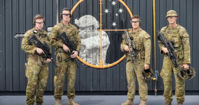 From left, Privates Shane Bagley, Frank Atkinson, Jack Dawes and Aleksandar Radovic in front of the first live-fire range-in-a-box in HMAS Adelaide. Story by Lieutenant Peter Kuschert. Photo by Leading Seaman Sittichai Sakonpoonpol.