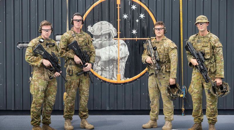 From left, Privates Shane Bagley, Frank Atkinson, Jack Dawes and Aleksandar Radovic in front of the first live-fire range-in-a-box in HMAS Adelaide. Story by Lieutenant Peter Kuschert. Photo by Leading Seaman Sittichai Sakonpoonpol.