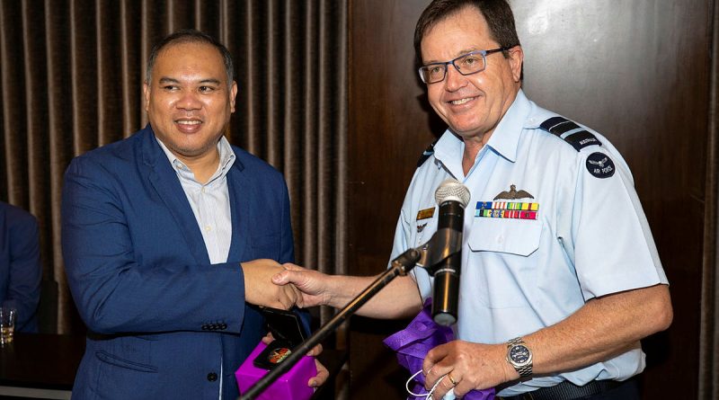 ADF Deputy Chief Joint Operations Command Air Vice-Marshal Mike Kitcher, right, presents a gift to the Office of Civil Defence Deputy Administrator for Operations, Assistant Secretary Bernardo Rafaelito Alejandro IV. Story by Captain Zoe Griffyn. Photo by Brandon Grey.