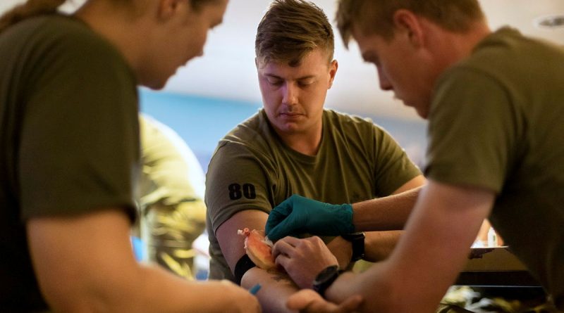 Private Samuel Sutcliffe, centre, from 1st Battalion, Royal Australian Regiment, volunteers as a patient during combat first-aid training. Story by Lieutenant Amy Johnson. Photos by Leading Seaman Sittichai Sakonpoonpol.