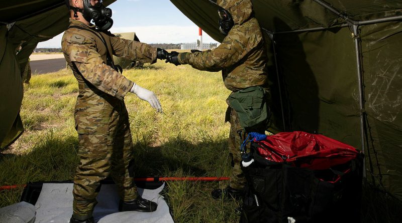 Combat Support Group aviators assisting role players during a decontamination scenario during Exercise Toxic Gauntlet. Story by Flying Officer Greg Hinks. Photo by Corporal Brett Sherriff.