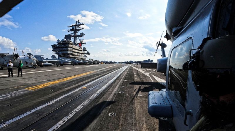 Leading Seaman Aircrewman Jake Williams looks out from HMAS Hobart's embarked MH-60R helicopter ‘Carnage’ during a cross-deck onto US Navy Aircraft Carrier, USS Ronald Reagan. Story by Lieutenant Brendan Trembath. Photo by Able Seaman Emily Johnson.