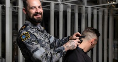 Chief Petty Officer Jessie McFarland runs a barbershop for charity on board HMAS Adelaide. Story by Flying Officer Brent Moloney. Photo by Leading Seaman Sittichai Sakonpoonpol.