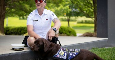 Able Seaman Taryn Dickens with her assistance dog, Gigi, at Brindabella Park, ACT. Story and photo by Private Nicholas Marquis.