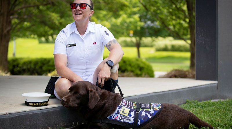 Able Seaman Taryn Dickens with her assistance dog, Gigi, at Brindabella Park, ACT. Story and photo by Private Nicholas Marquis.