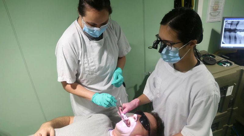 Leading Seaman Stacey Allen, left, and Lieutenant Danica Zhan provide dental care to Leading Seaman Damien Ripley while embarked in HMAS Stalwart. Story by Lieutenant Brendan Trembath. Photo by Chief Petty Officer Aaron Robinson.