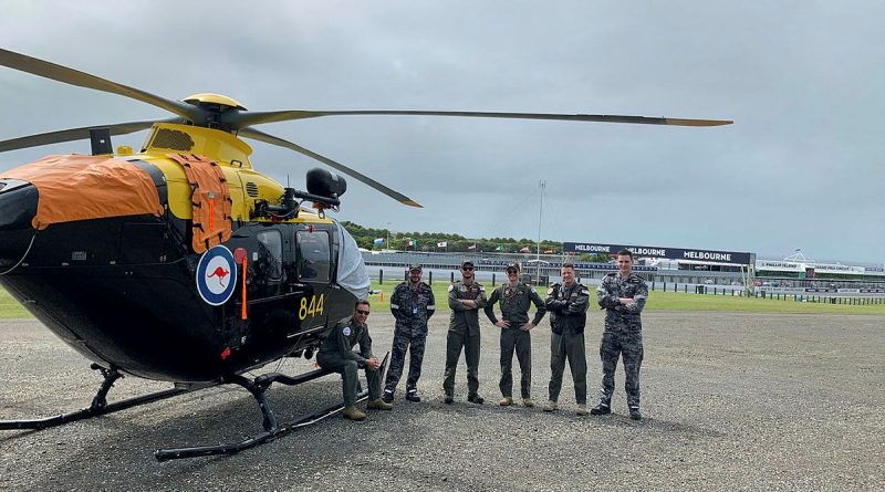 723 Squadron representatives get their EC-135 training helicopter ready ahead of a big weekend supporting the World Superbike Championship at Phillip Island.