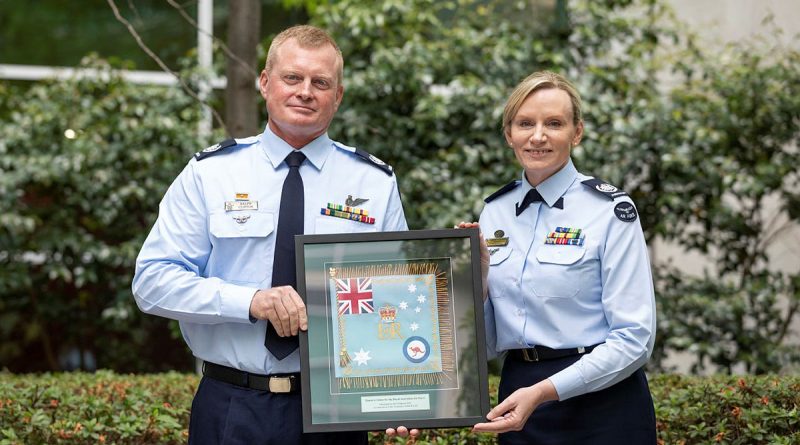 The outgoing Warrant Officer of the Air Force, WOFF-AF Fiona Grasby, hands over the mantle to her successor, WOFF-AF Ralph Clifton. Story by John Noble. Photo by Nicole Mankowski.