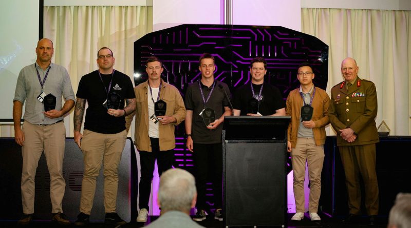 Chief of Joint Capabilities Lieutenant General John Frewen, right, with the winning ADF team in the capture-the-flag competition at the 2022 Cyber Skills Challenge. Photo by Corporal Olivia Cameron.