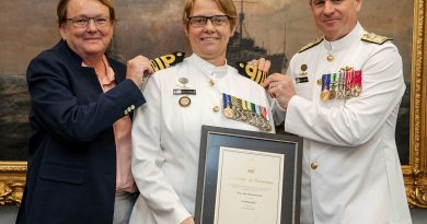 Warrant Officer of the Navy Deb Butterworth, centre, receives her promotion to commander from the Chief of Navy Vice Admiral Mark Hammond, right, accompanied by her partner Tracy. Story by Sub-Lieutenant Tahlia Merigan. Photo by Petty Officer Bradley Darvill.