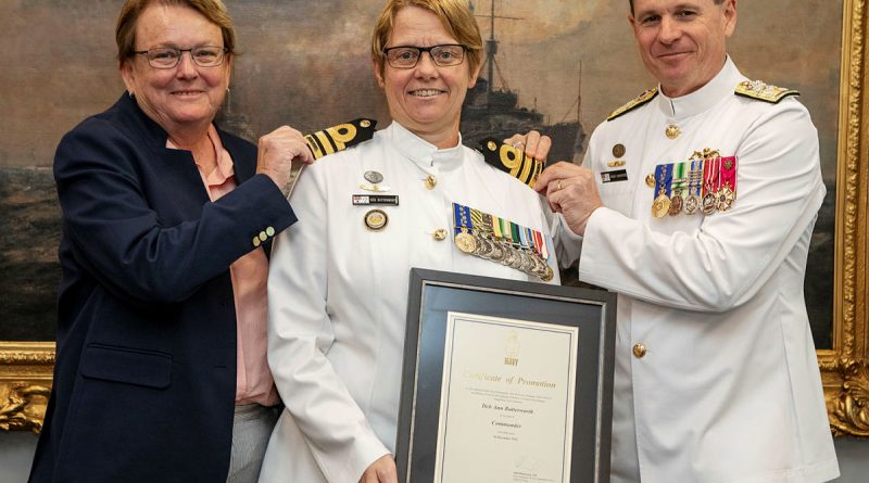 Warrant Officer of the Navy Deb Butterworth, centre, receives her promotion to commander from the Chief of Navy Vice Admiral Mark Hammond, right, accompanied by her partner Tracy. Story by Sub-Lieutenant Tahlia Merigan. Photo by Petty Officer Bradley Darvill.