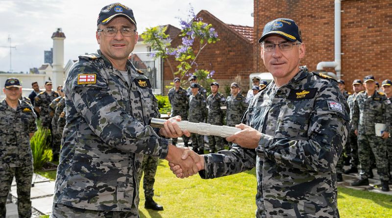 Rear Admiral Jonathan Earley hands over the 'weight of command' of His Majesty’s Australian Fleet to Rear Admiral Chris Smith during a ceremony at Fleet Headquarters, HMAS Kuttabul in Sydney. Story by Meg Van Lohuizen. Photo by Leading Seaman Matthew Lyall.