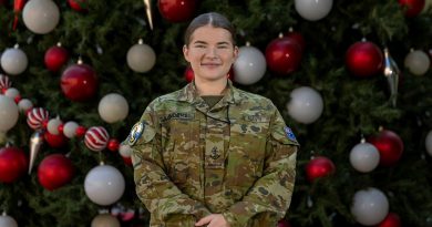 Leading Seaman Olivia Saunders stands in front of the US base's Christmas tree, Bahrain. Story and photo by Corporal Jacob Joseph.