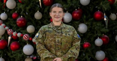 Leading Seaman Olivia Saunders stands in front of the US base's Christmas tree, Bahrain. Story and photo by Corporal Jacob Joseph.