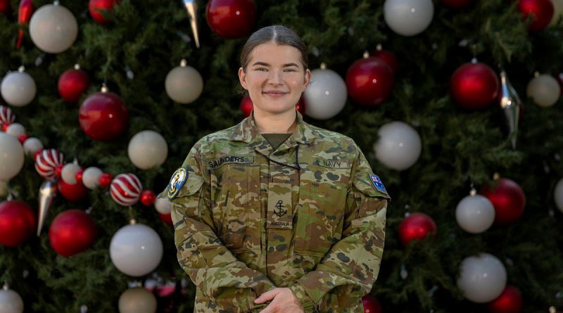 Leading Seaman Olivia Saunders stands in front of the US base's Christmas tree, Bahrain. Story and photo by Corporal Jacob Joseph.