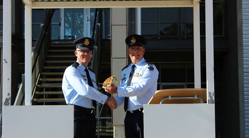 Outgoing Commander No 1 Recruit Training Unit Wing Commander Darren Dolan (left) transfers command of the unit to Wing Commander David Borg during a Transfer of Authority parade on December 2 at RAAF Base Wagga, NSW. Story by Squadron Leader Matt Kelly. Photo by Corporal Kristy Watson.