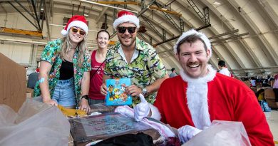 Corporal Maddison Graham, RAAF; Lieutenant Colonel Kira Coffey, PACAF; Sergeant Ben Rhodes, RAAF; and Captain Andrew Zaldibar, PACAF put the finishing touches to a load during Operation Christmas Drop's Bundle Build Day. Photo by Sergeant Vanessa Parker.